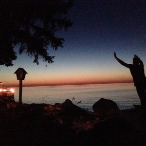 Person at the beach playing in front of the sunset